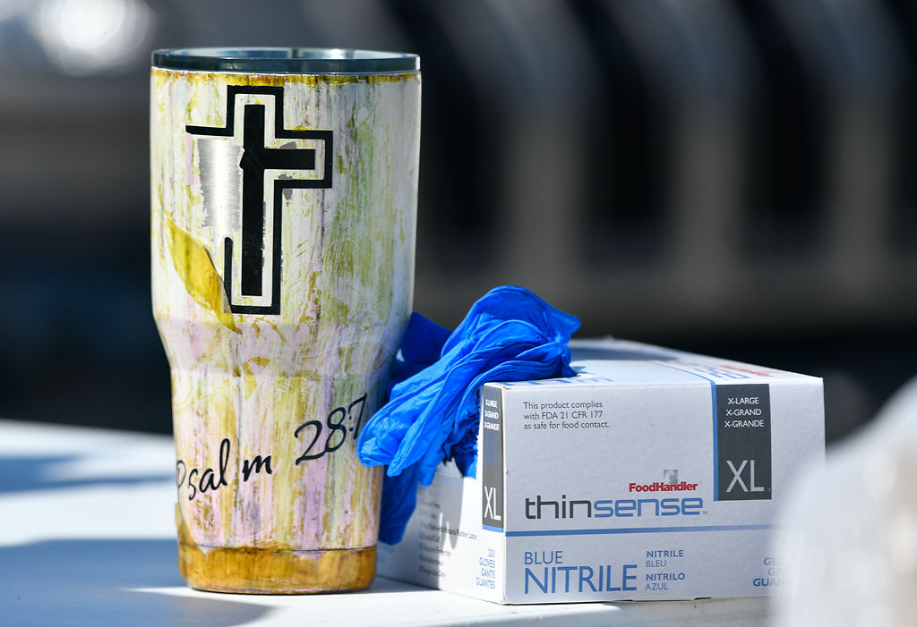 Rev. James Gray’s coffee mug next to a box of gloves